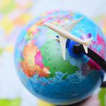 Travel background concept / Airplane Traveler's fly Airlines worldwide with plane on on world globe